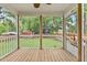 Screened porch features wood flooring, white railing and view of the backyard at 12449 W Pamlico St, Middlesex, NC 27557