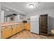 Basement kitchen with wood cabinets, sink, refrigerator, and wine fridge at 13121 Sargas St, Raleigh, NC 27614