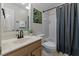 Neutral-toned bathroom featuring an integrated shower and tub, vanity and toilet at 13121 Sargas St, Raleigh, NC 27614
