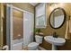 Traditional bathroom with pedestal sink, patterned wallpaper, and bathtub shower combo at 13121 Sargas St, Raleigh, NC 27614