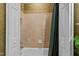 Clean bathroom with white tiled shower/tub featuring a neutral shower curtain and shelving at 13121 Sargas St, Raleigh, NC 27614