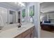 Bathroom featuring a wide mirror, marble countertop, and stylish faucet at 13121 Sargas St, Raleigh, NC 27614