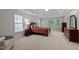 Spacious bedroom with tray ceilings, plush carpeting, and multiple windows providing ample natural light at 13121 Sargas St, Raleigh, NC 27614