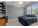 Bedroom featuring a comfortable bed, plush carpeting, a built-in desk, and ample natural light at 13121 Sargas St, Raleigh, NC 27614