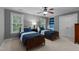 Charming bedroom featuring two beds with blue-striped bedding, neutral walls and built-in shelves at 13121 Sargas St, Raleigh, NC 27614