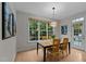 Bright dining area featuring a modern light fixture, and a large window overlooking the backyard at 13121 Sargas St, Raleigh, NC 27614