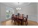 Elegant dining room featuring hardwood floors, a modern chandelier, and wainscoting at 13121 Sargas St, Raleigh, NC 27614