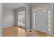 Bright foyer with hardwood floors, white trim, and a large window providing natural light at 13121 Sargas St, Raleigh, NC 27614