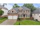 Charming two-story brick home with a well-manicured lawn and beautiful landscaping at 13121 Sargas St, Raleigh, NC 27614