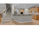 Open-concept kitchen featuring a breakfast bar, wood cabinets, and modern appliances at 13121 Sargas St, Raleigh, NC 27614