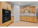 Well-lit kitchen boasting ample cabinet space, modern appliances, and stylish backsplash at 13121 Sargas St, Raleigh, NC 27614