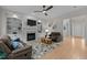 Comfortable living room featuring a fireplace, built-in bookshelves, and hardwood flooring at 13121 Sargas St, Raleigh, NC 27614