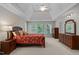 Spacious main bedroom with large windows, tray ceilings, and wood furniture at 13121 Sargas St, Raleigh, NC 27614