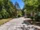 Backyard with trees and greenery with a screen porch attached to the back of the home at 1420 Norwood Crest Ct, Raleigh, NC 27614