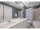 Bathroom with double sinks, complemented by a tub-shower combo with a gray and white curtain, is perfect for all needs at 1420 Norwood Crest Ct, Raleigh, NC 27614