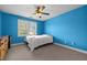 Carpeted bedroom with ceiling fan and view of exterior at 1420 Norwood Crest Ct, Raleigh, NC 27614