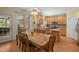 Eat-in kitchen with natural wood cabinets, breakfast bar, and access to outdoor area at 1420 Norwood Crest Ct, Raleigh, NC 27614