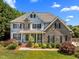 Charming two-story home with stone accents, mature landscaping, and a welcoming front porch at 1420 Norwood Crest Ct, Raleigh, NC 27614