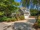 Well-maintained home features manicured landscaping, a stone facade, and a large driveway at 1420 Norwood Crest Ct, Raleigh, NC 27614