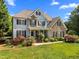 Two-story home with stone accents, manicured lawn, and mature landscaping at 1420 Norwood Crest Ct, Raleigh, NC 27614