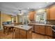 Kitchen with wooden cabinets and island with dining area at 1420 Norwood Crest Ct, Raleigh, NC 27614
