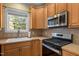 Kitchen features stainless steel appliances, window over sink, and tile backsplash at 1420 Norwood Crest Ct, Raleigh, NC 27614