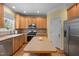 Bright kitchen features wood cabinets, island, and stainless steel appliances at 1420 Norwood Crest Ct, Raleigh, NC 27614