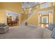 Cozy carpeted living room with staircase, fireplace, and views of dining area at 1420 Norwood Crest Ct, Raleigh, NC 27614
