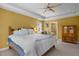 This primary bedroom features a ceiling fan and an ensuite bathroom, providing a comfortable and private retreat at 1420 Norwood Crest Ct, Raleigh, NC 27614