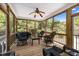 The screened-in porch is enhanced by a ceiling fan, with a table and chairs creating a serene outdoor living space at 1420 Norwood Crest Ct, Raleigh, NC 27614