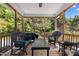 Relaxing screened porch features wicker furniture, a ceiling fan, and a wooded backyard view at 1420 Norwood Crest Ct, Raleigh, NC 27614