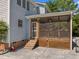 View of the home's screened porch with wooden lattice and concrete patio at 1420 Norwood Crest Ct, Raleigh, NC 27614
