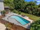 Aerial view of a swimming pool with a picnic table and a wooded area behind a home at 1420 Norwood Crest Ct, Raleigh, NC 27614