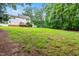 Expansive backyard with lush lawn and mature trees, ideal for outdoor activities and relaxation at 1420 Taylor Farm Rd, Raleigh, NC 27603