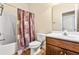 Cozy bathroom features a shower-tub combination and vanity with a wooden cabinet at 1420 Taylor Farm Rd, Raleigh, NC 27603