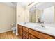 Bathroom featuring wooden cabinets, double sinks and a large mirror at 1420 Taylor Farm Rd, Raleigh, NC 27603