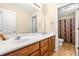Bathroom with double vanity, white countertop, wood cabinets and an adjoining toilet and shower area at 1420 Taylor Farm Rd, Raleigh, NC 27603