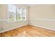 Bright bedroom featuring hardwood floors, neutral walls, and a large window at 1420 Taylor Farm Rd, Raleigh, NC 27603