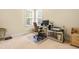 Bright, carpeted bedroom with large windows and a dedicated desk setup perfect for a home office at 1420 Taylor Farm Rd, Raleigh, NC 27603