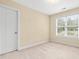 Cozy bedroom featuring a bright window and neutral carpet flooring at 1420 Taylor Farm Rd, Raleigh, NC 27603