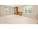 Spacious bedroom with neutral carpeting, built in desk and shelves and multiple large windows at 1420 Taylor Farm Rd, Raleigh, NC 27603