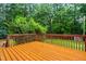 Large wood deck offering picturesque views of the surrounding lush greenery and wooded area at 1420 Taylor Farm Rd, Raleigh, NC 27603