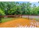 Wooden deck overlooking lush green trees and foliage, offering a serene outdoor space at 1420 Taylor Farm Rd, Raleigh, NC 27603