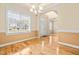 Sunny dining area featuring hardwood floors, stylish lighting, and generous window views at 1420 Taylor Farm Rd, Raleigh, NC 27603