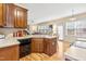Kitchen area featuring an island with seating, wood cabinets, and a view of the living room at 1420 Taylor Farm Rd, Raleigh, NC 27603
