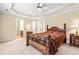Spacious main bedroom with tray ceiling and ensuite bathroom and large furnishings at 1420 Taylor Farm Rd, Raleigh, NC 27603