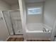 Bathroom featuring a separate shower, soaking tub under a window, and wood look floors at 151 Oakfield Trace Dr, Four Oaks, NC 27524