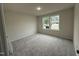 Inviting bedroom featuring double windows, neutral walls, carpet, and lots of natural light at 151 Oakfield Trace Dr, Four Oaks, NC 27524