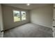 Cozy bedroom with natural light through double windows, carpet, and neutral walls at 151 Oakfield Trace Dr, Four Oaks, NC 27524