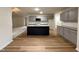 Stylish kitchen with gray cabinets, an island, and hardwood floors, offering a sleek and functional cooking space at 151 Oakfield Trace Dr, Four Oaks, NC 27524